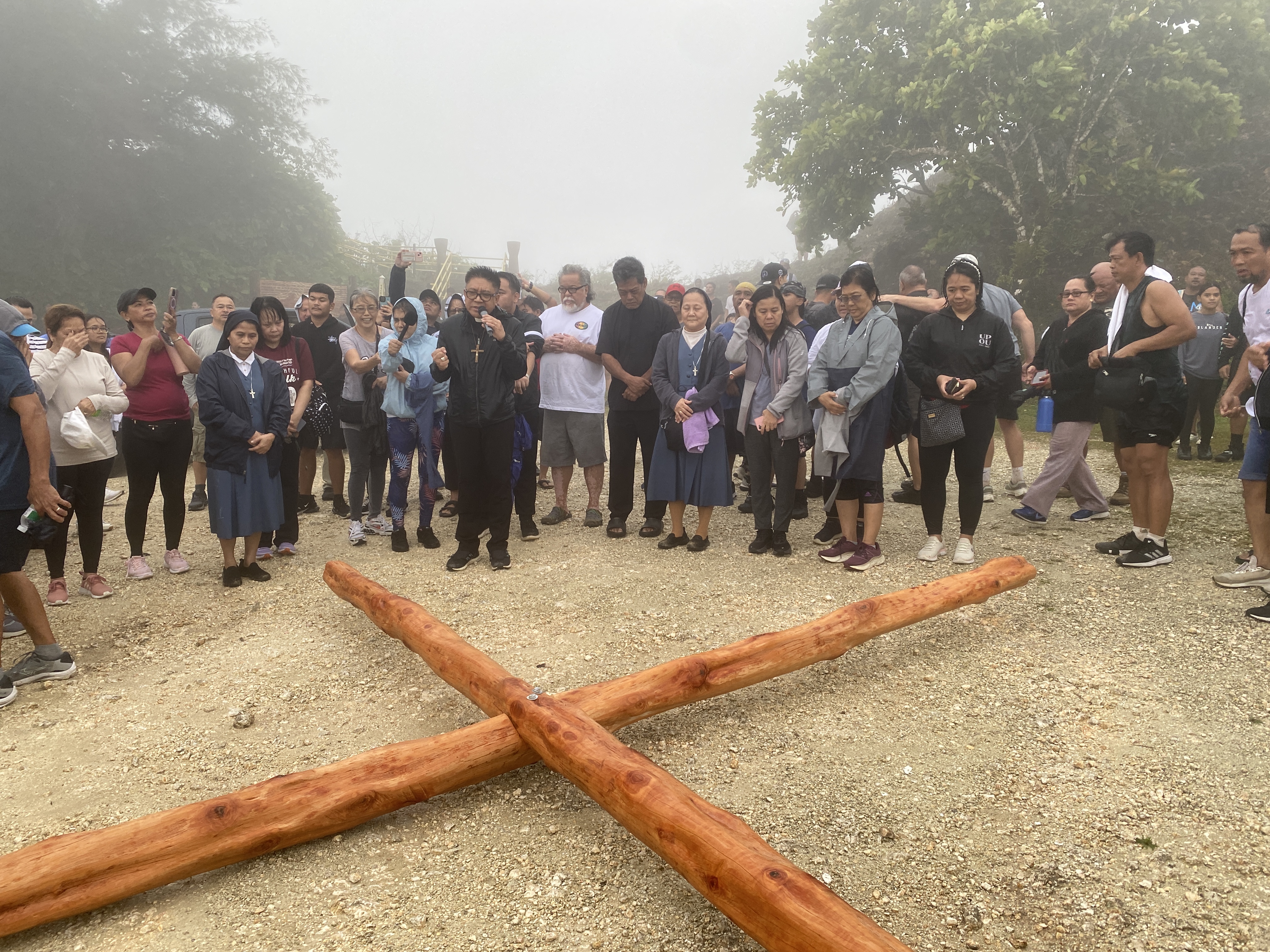 Bishop Romeo Convocar blessed the wooden cross that volunteers carried on their shoulders up Mt. Tapochao.