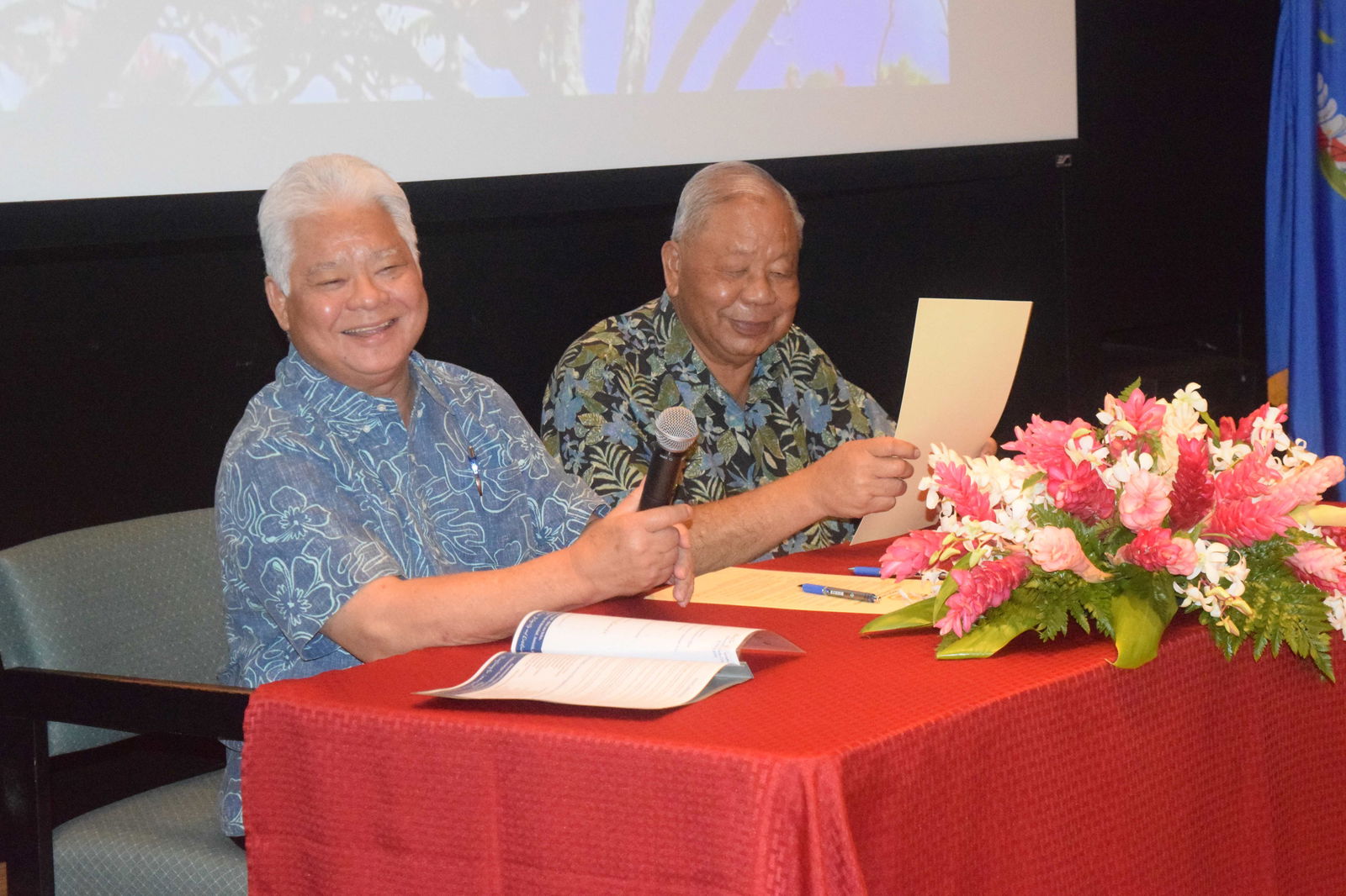 Gov. Arnold I. Palacios and Lt. Gov. David M. Apatang smile as they start to read the proclamation designating May 4 to 10, 2025 as Public Service Recognition Week at American Memorial Park’s indoor theater on Tuesday.Photo by Emmanuel T. Erediano