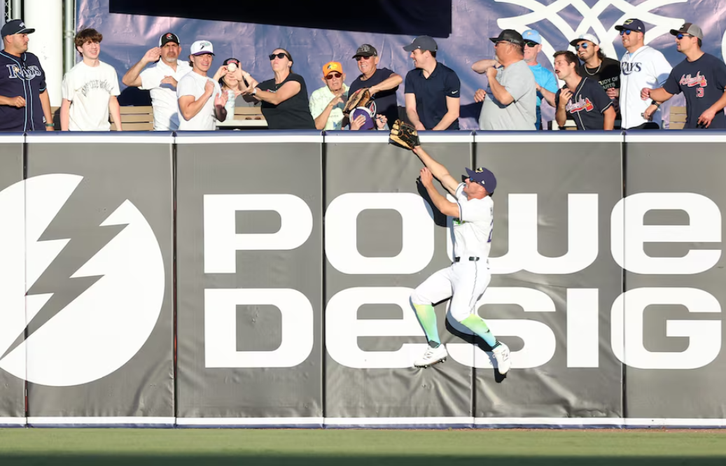 Tampa Bay Rays outfielder Kameron Misner (26) jumps as a fan catches the home run ball during the ninth inning against the Atlanta Braves at George M. Steinbrenner Field in St. Petersburg, Florida, April 12, 2025.Photo by Kim Klement Neitzel-Imagn Images