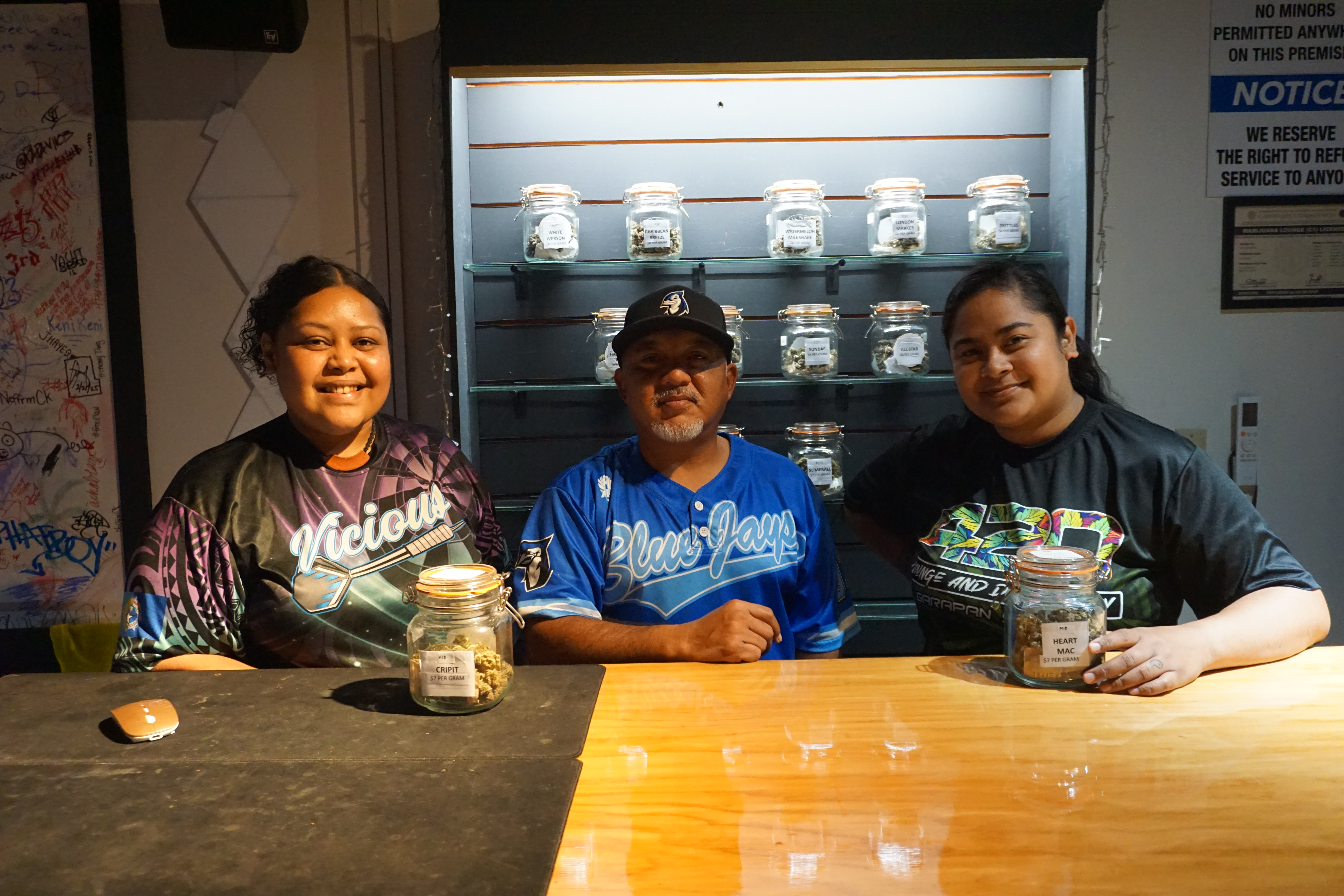 Jamie Hayes, left, is joined by her coworkers at 420 Lounge in Garapan.