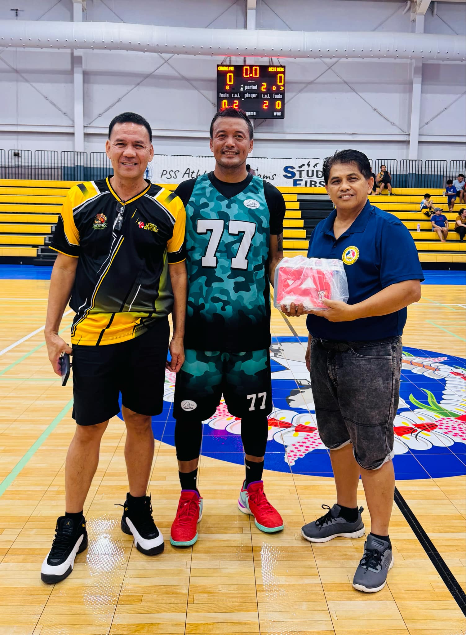 A+Consulting's Alis Robles, center, poses with Joselito Espino, right, and Bernie Ebuen before receiving  the Best Player of the Game prize.2 bd center