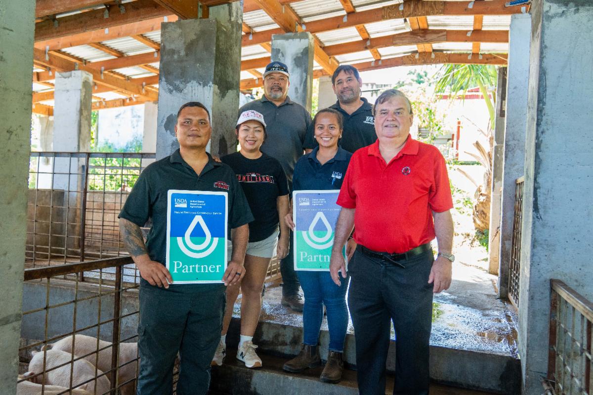 Kumoi Farms owners Simon and Crystal Deleon Guerrero gather for a group photo with Dr. Adrian Ares of Northern Marianas College-Cooperative Research, Extension, and Education Services and Sollyann Takai of Natural Resource Conservation Services in celebration of the Kumoi Farms’ Sustaining Pig Farming in the Marianas Initiative.NMC photo