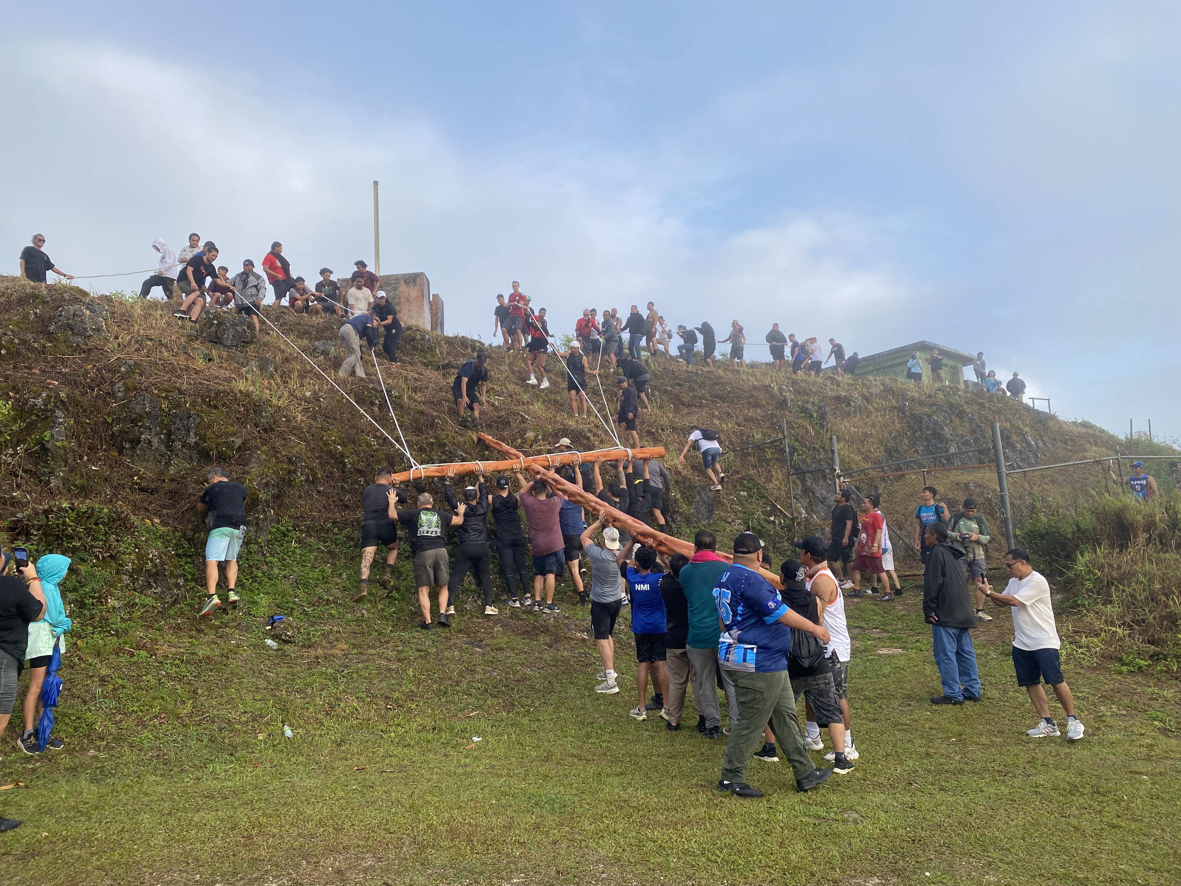 Devotees carried the cross to Mt. Tapochao’s summit on Good Friday.