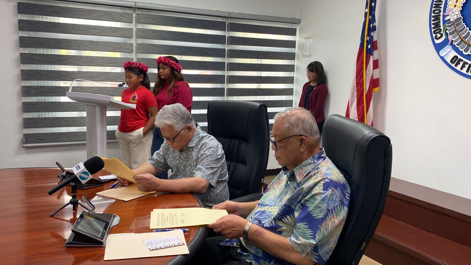 Iris Quitugua, standing with her mother Jaclyn, reads from the proclamation designating April as Oral Cancer Awareness Month.