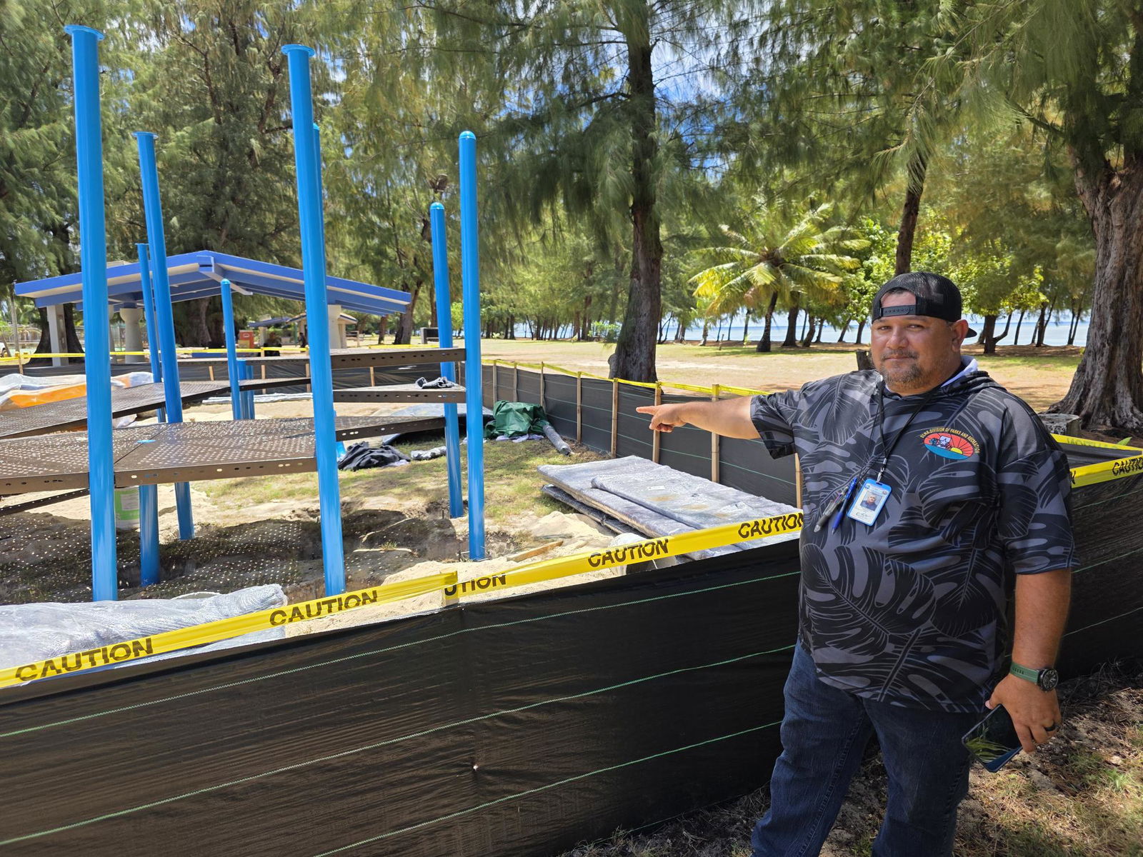 Parks and Rec Director Mike Cruz points to the construction of a new playground at Laly 4 in Chalan Kanoa.