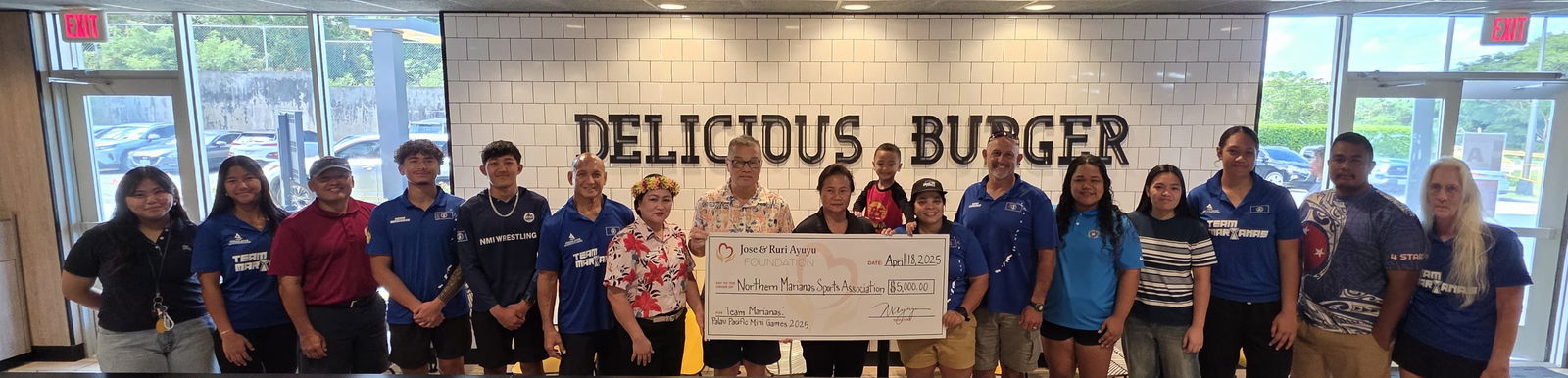 Northern Marianas Sports Association Board President Jerry Tan and McDonald's Restaurant of Guam and Saipan owner/operator Marcia Ayuyu hold the ceremonial check for $5,000 that McDonald’s donated to Team Marianas on Friday at McDonald’s Middle Road.Photo by James Sablan
