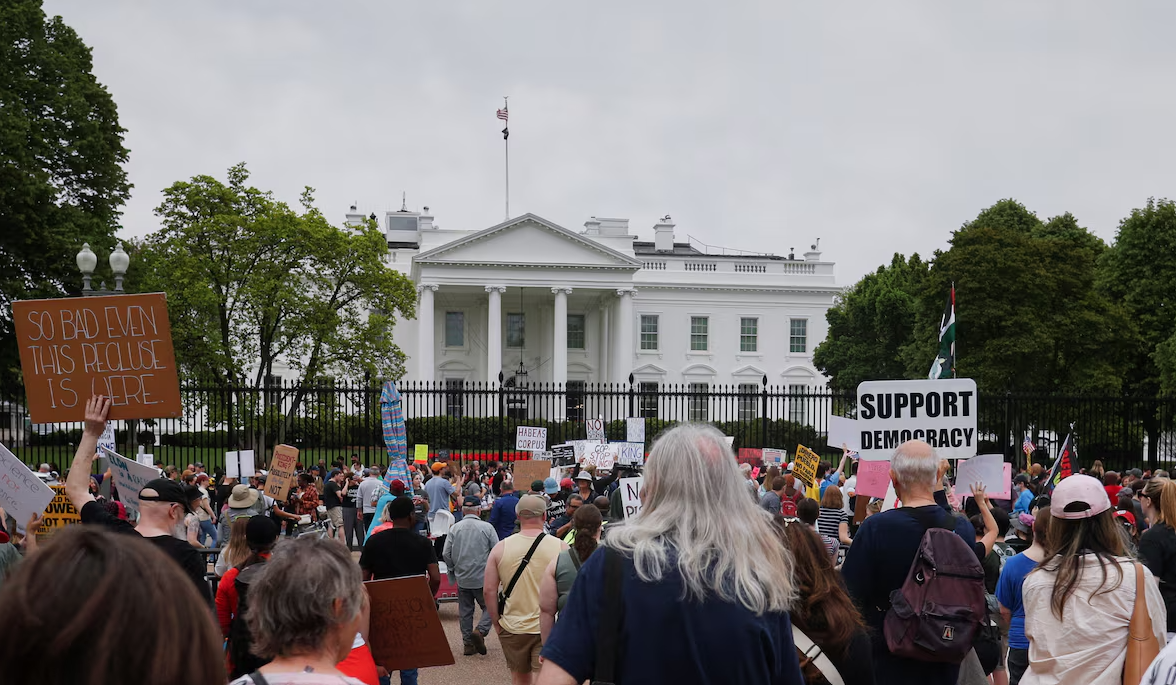 People take part in a protest against President Donald Trump, tariffs, deportations, a variety of other policies, and Elon Musk at the White House in one of many demonstrations taking place nationwide, in Washington, D.C., on April 19, 2025.REUTERS
