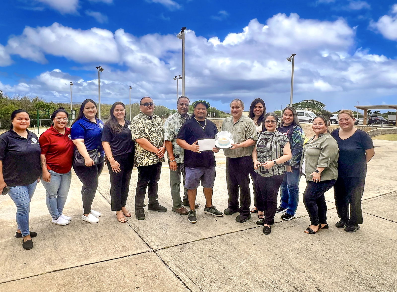 With Laolao Bay as a backdrop, Chacha Ocean View Middle School Vice Principal Dr. Benjamin Seman poses for a photo with Acting BOE Chairman Anthony Dela Cruz Barcinas, BOE member Andrew L. Orsini, Acting Commissioner of Education Jacqueline P. Che and Principal Carla Sablan.