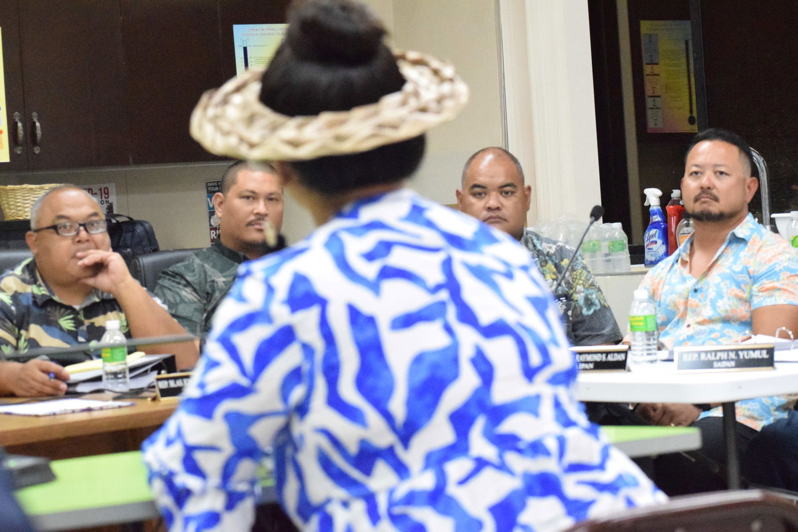 Rep. Blas Jonathan Attao, Vice Speaker Diego Vince Camacho, Rep. Malcolm Omar, and Rep. Joel Camacho listen to former Rep. Sheila Babauta, back to the camera, during a joint public hearing conducted by the Senate Committee on Resources, Economic Development, and Workforce and the House Committee on Natural Resources at the Tanapag Youth Center on Tuesday.Photo by Emmanuel T. Erediano