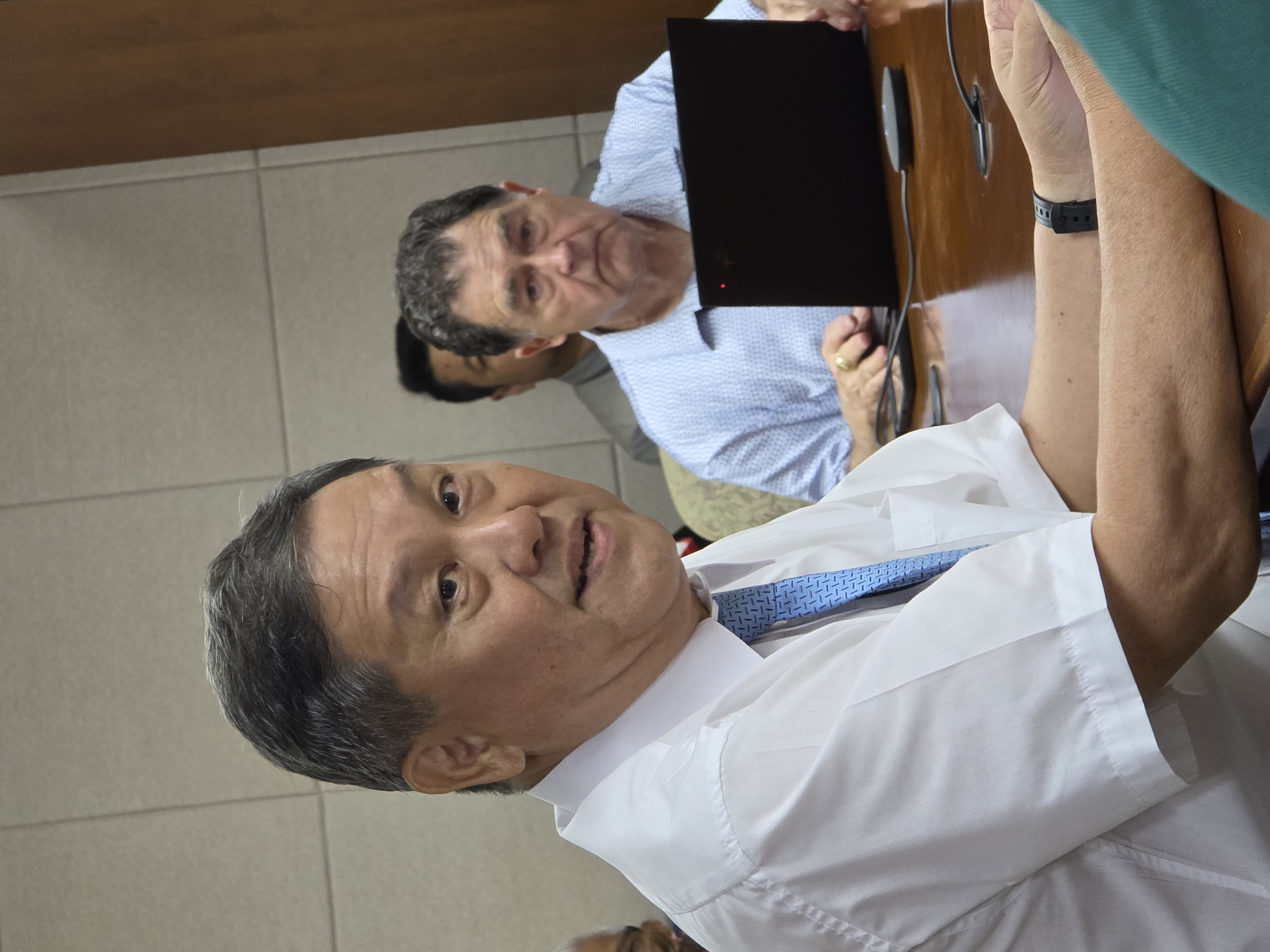 Agape Christian School Administrator Pastor Kok H. Pang speaks at a Commonwealth Public Utilities Commission meeting on Friday while Commonwealth Utilities Corporation Executive Director Kevin Watson looks on.Photo by Bryan Manabat                                   