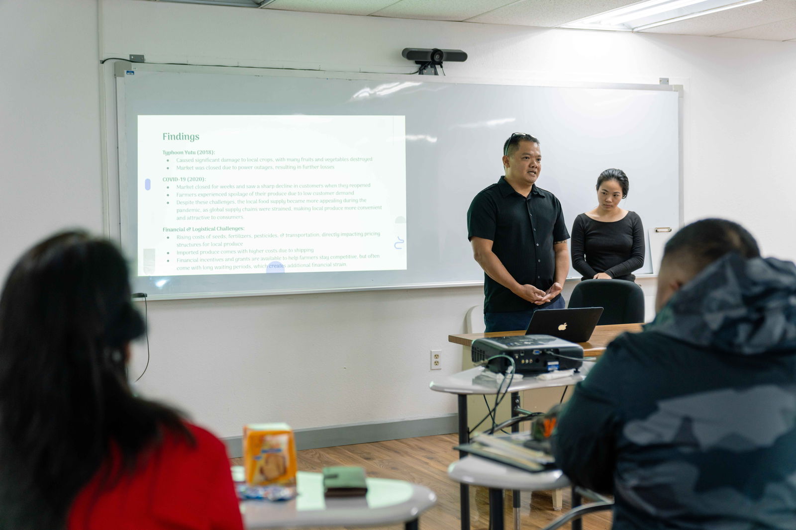 NMC School of Business Students Edward John Sablan and Susan Ma discuss their Business Cooperative Education project findings.NMC photo
