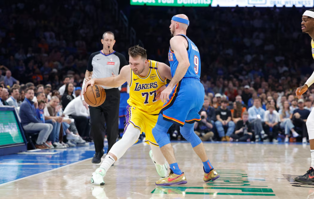 Los Angeles Lakers guard Luka Doncic (77) moves the ball down the court against Oklahoma City Thunder guard Alex Caruso (9) during the second quarter at Paycom Center in Oklahoma City, April 8, 2025.Photo by Alonzo Adams/Imagn Images