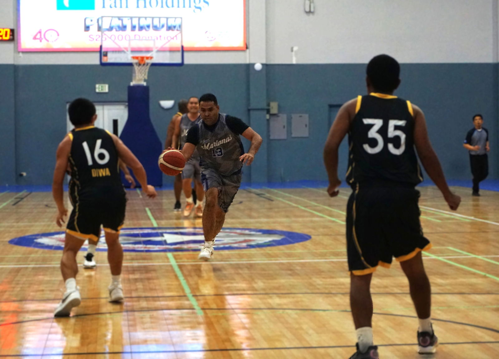 Marianas’ Marvin Rabauliman attempts to drive between two defenders during a game against Unity Trade in the NMIBF Michelob Ultra Cup 2025 at the Ada gym on Tuesday.Photo by James F. Sablan Jr.