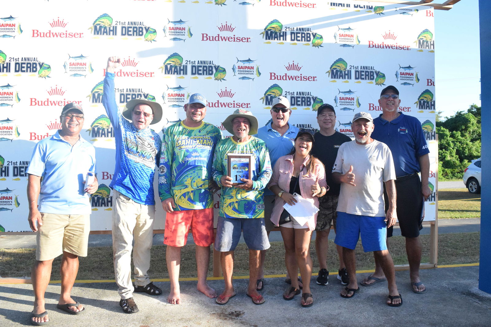 Sweet Candy Captain George Moses Sr., center, holds their award as he and anglers George Moses Jr. third left, and Tom Tucker, second left, pose for a photo with Saipan Fishermen's Association Vice President Scott Schular, third right back row, Secretary Mara Schular, second right, front row, treasurer Martin Duenas, second right back row, Solicitation Chairman Curtis Dancoe, right, and SFA members. Diego T. Benavente, left, and Joe Deleon Guerrero, right front row, during the 21st Annual Fishing Derby awards ceremony on Saturday at Smiling Cove Marina. Photo by Emmanuel T. Erediano