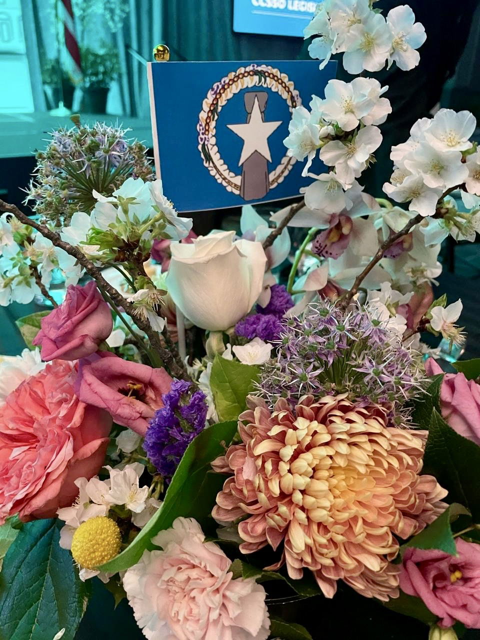 During PSS’s presentation, the banquet hall’s dining tables were adorned with flower centerpieces and miniature CNMI flags.