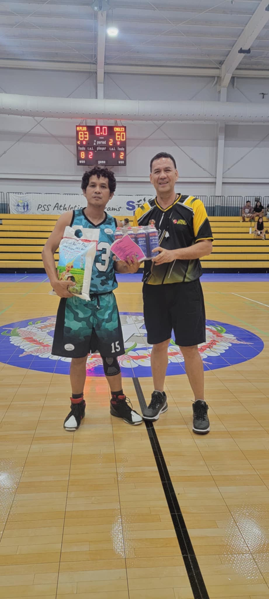 A+ Consulting’s Jun Estolas, Best Player of the Game, poses with League Commissioner Bernie Ebuen after receiving a pack of butane gas sponsored by Best Deal and a bag of rice sponsored by RJoy Manpower on Sunday at the Ada Gym.Contributed photo