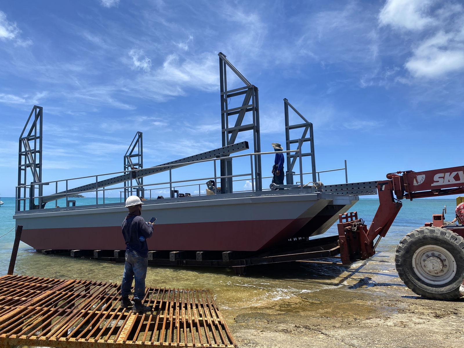 Tano Group launches its “jack” barge into the Saipan Lagoon from the Lower Base area, where it was fabricated.