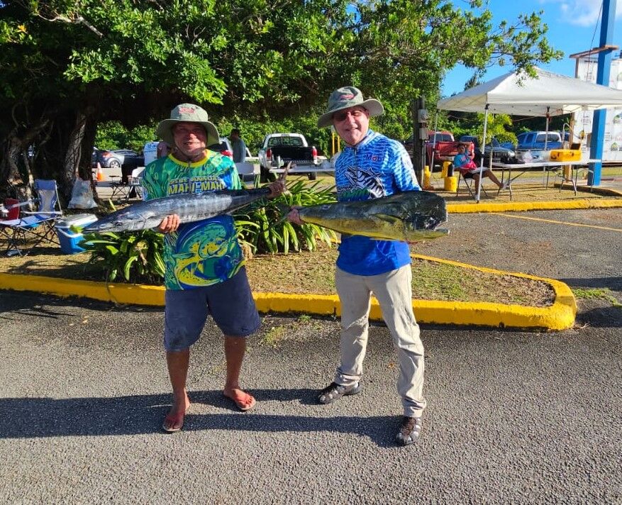 Sweet Candy angler Tom Tucker holds their winning 16.5-pound mahi-mahi, while boat captain George Moses Sr. displays a wahoo after returning to Smiling Cove Marina.Contributed photo