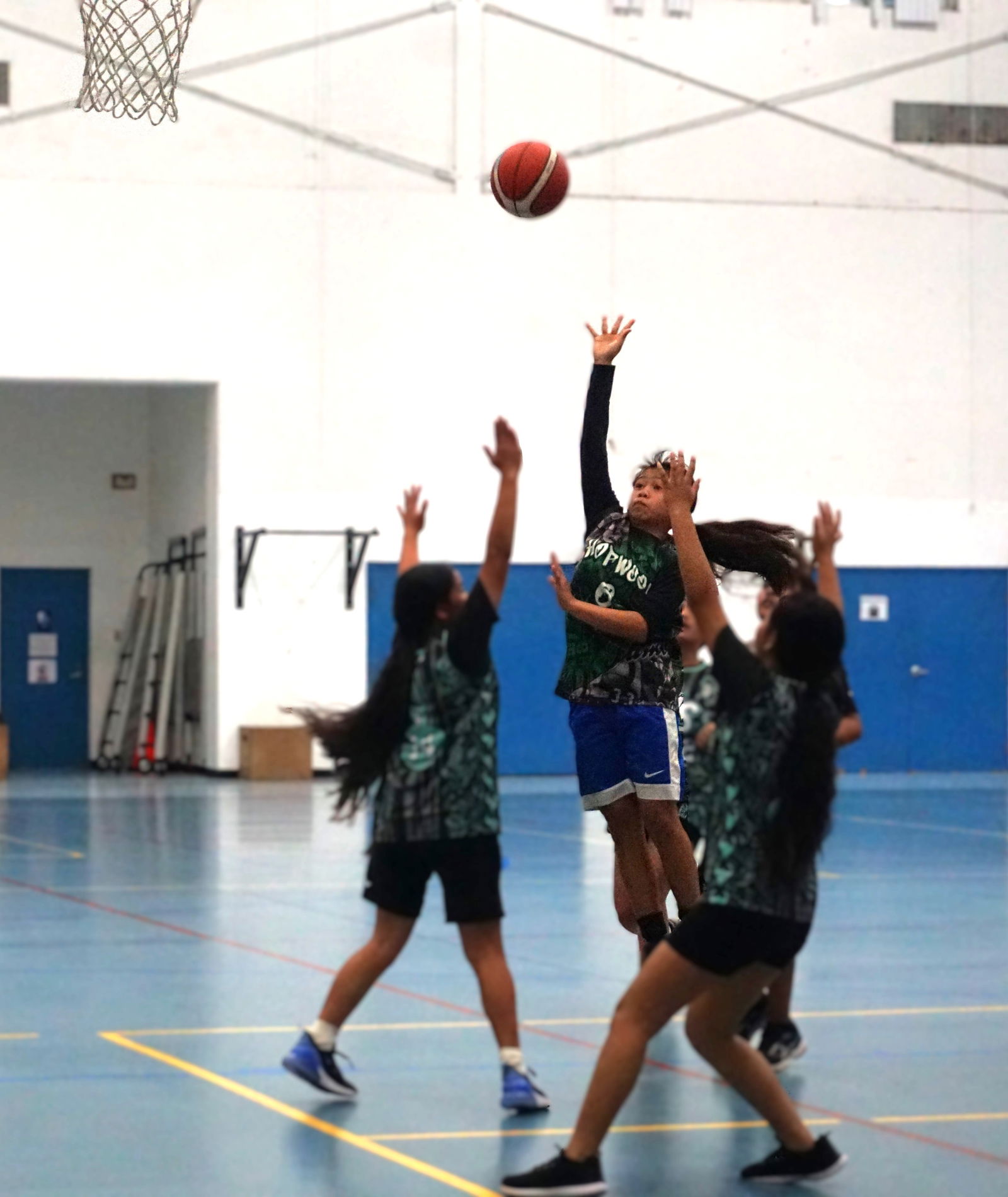 Hopwood Middle School's Anica Aquino takes a contested floater during the championship game against Tanapag Middle School.Photo by James F. Sablan Jr.