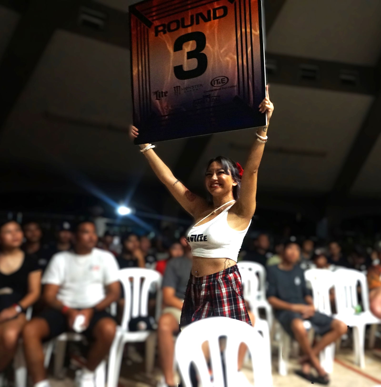 A ring girl signals the start of the third round during Ring of Fire 3 at the Garapan Round House on Saturday.Photo by James F. Sablan Jr.