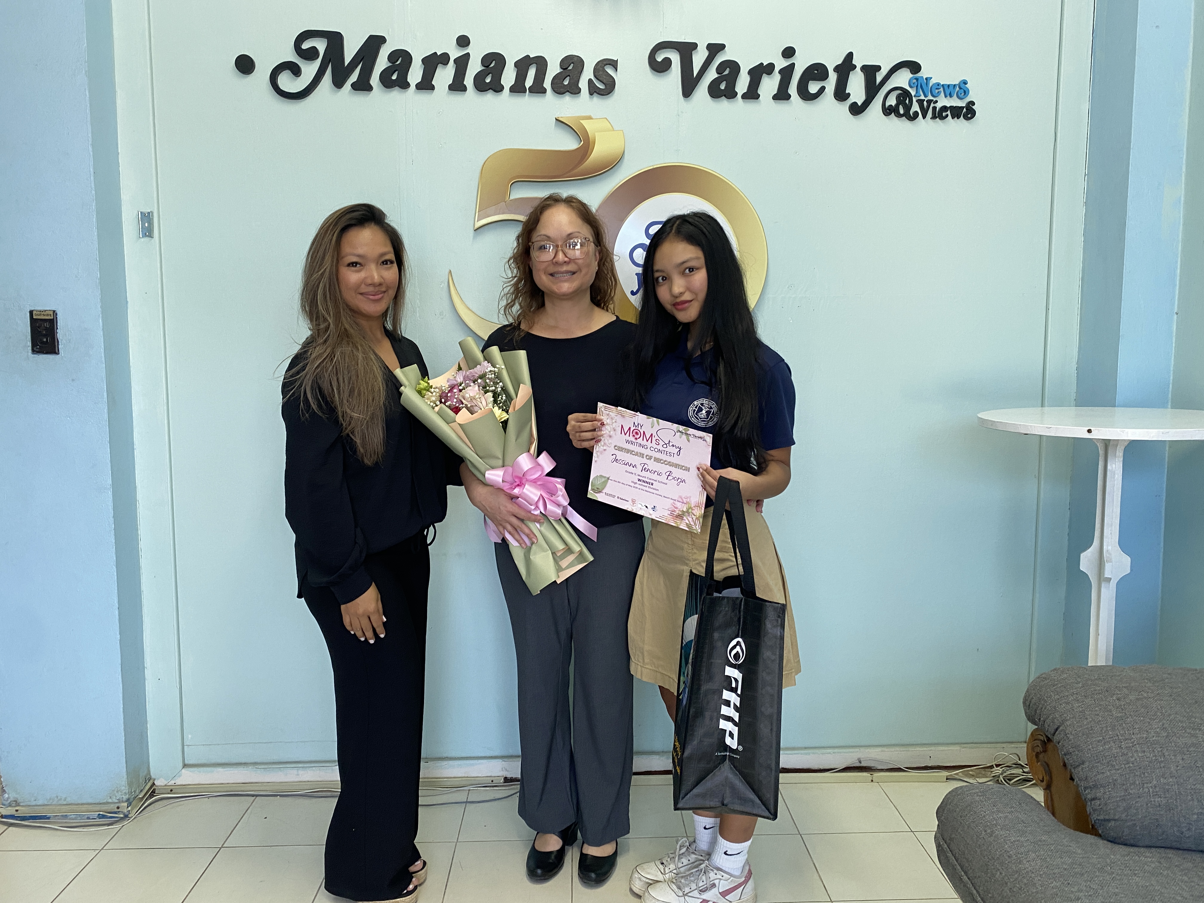 Eleventh grade Mount Carmel student Jessiana Tenorio, and her mother, center. 