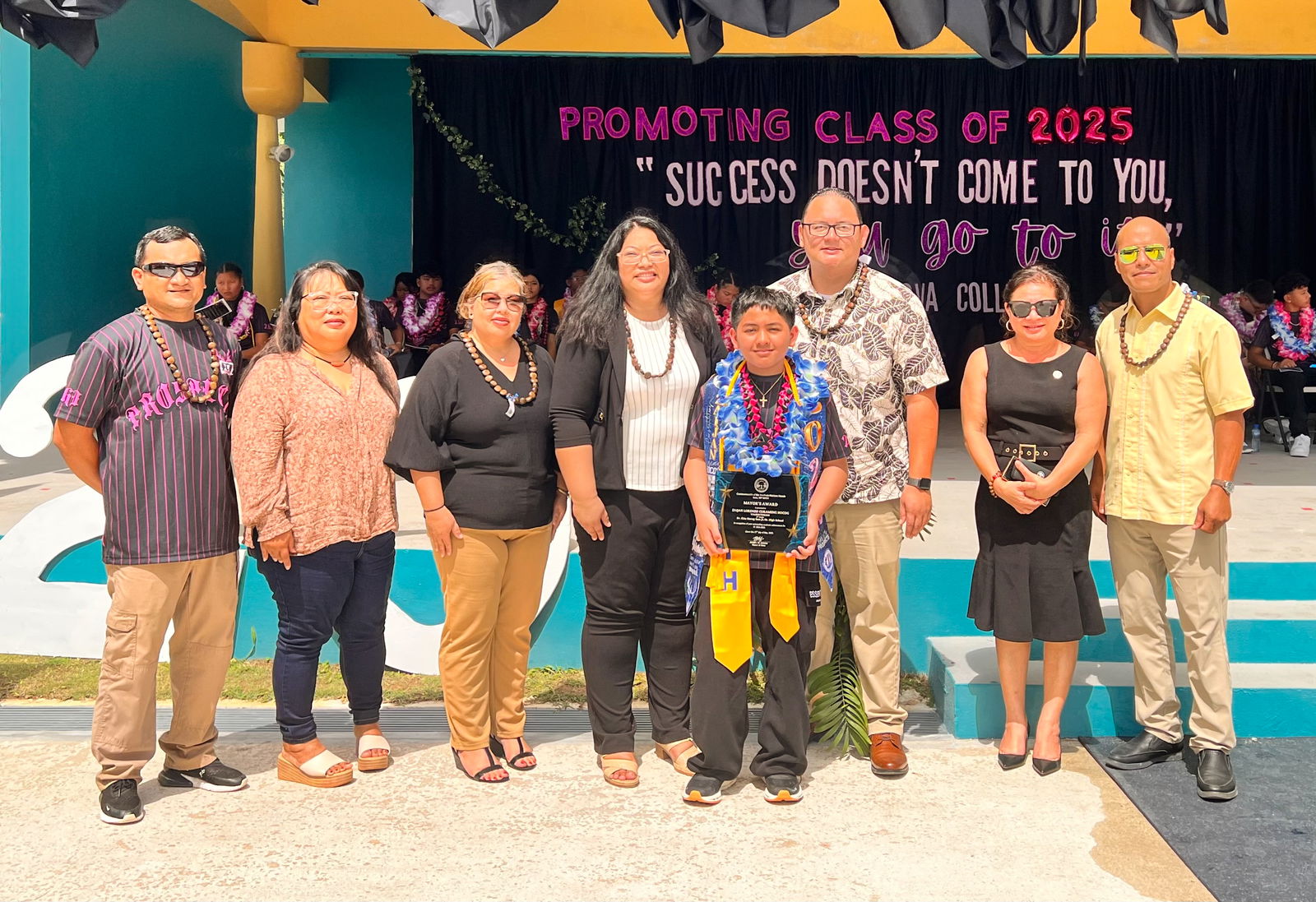 The Rota Mayor’s Award recipient is the class valedictorian, Zaijan Lorenzo Curameng Hocog. Also in photo are Mayor Aubry Hocog, members of the Rota delegation and the Municipal Council. 