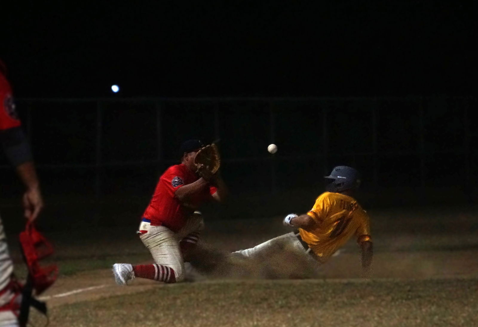 The Padres’ Ben Flores slides to beat the attempted pick off from the Cardinals’ third baseman Brian Camacho during the opening game of the 2025 Saipan Baseball League at the Francisco "Tan Ko" Palacios Baseball Field on Wednesday.Photo by James F. Sablan Jr.