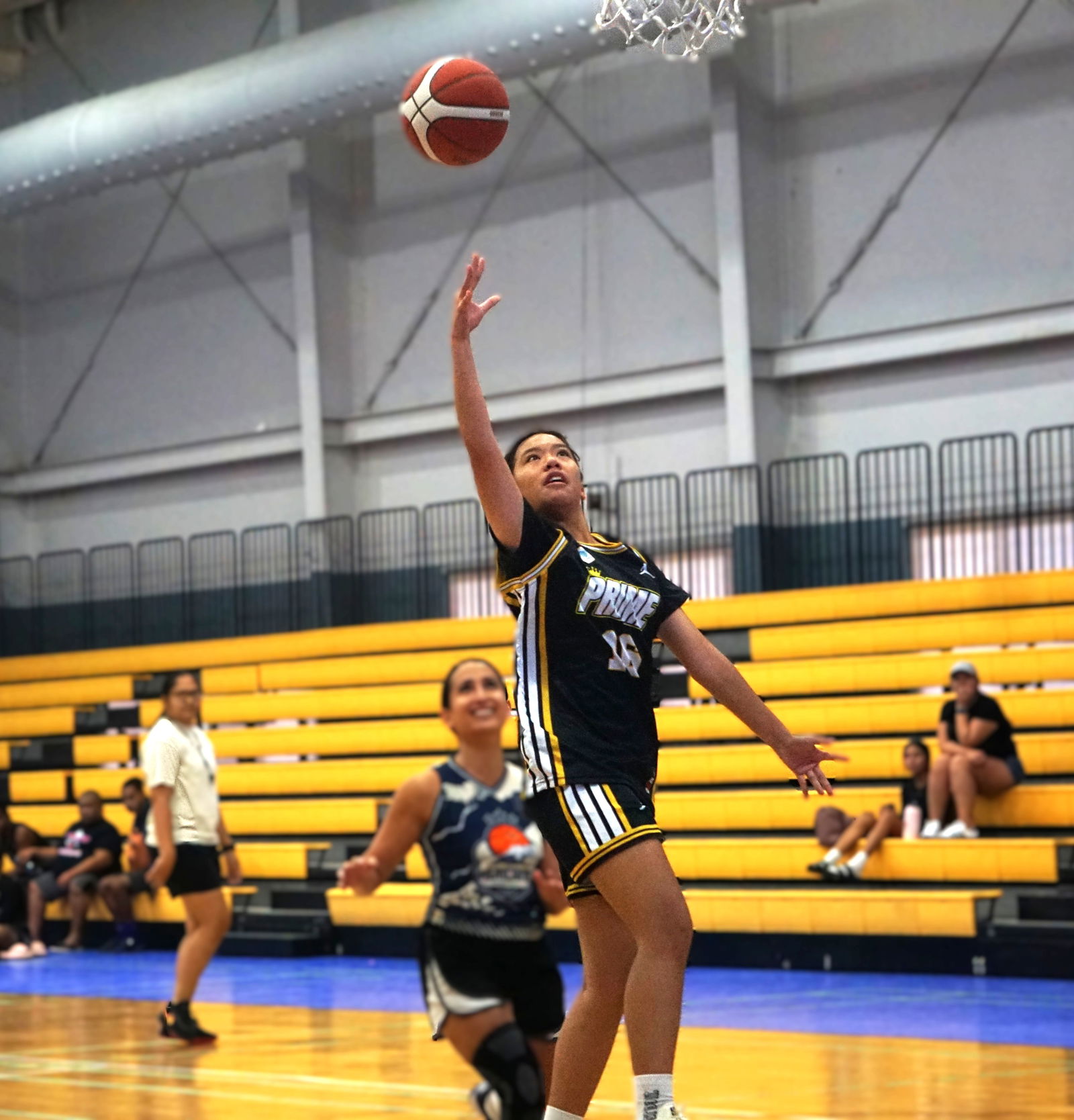 Prime's Venice Enriquez extends for the fastbreak finish during a game against Hericanes in the women's division of the 2025 Allied Pacific Environmental Corporation Basketball League at the Ada gym on Saturday.Photo by James F. Sablan Jr.