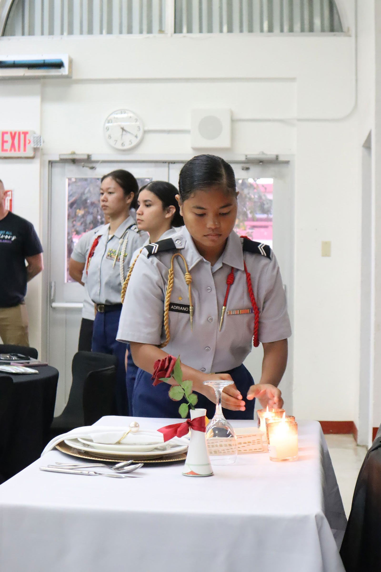 C/CPL Kya Adriano places down a candle during the “Fallen Comrade Ceremony.”Photo by C/CPT Sofia Del Rosario