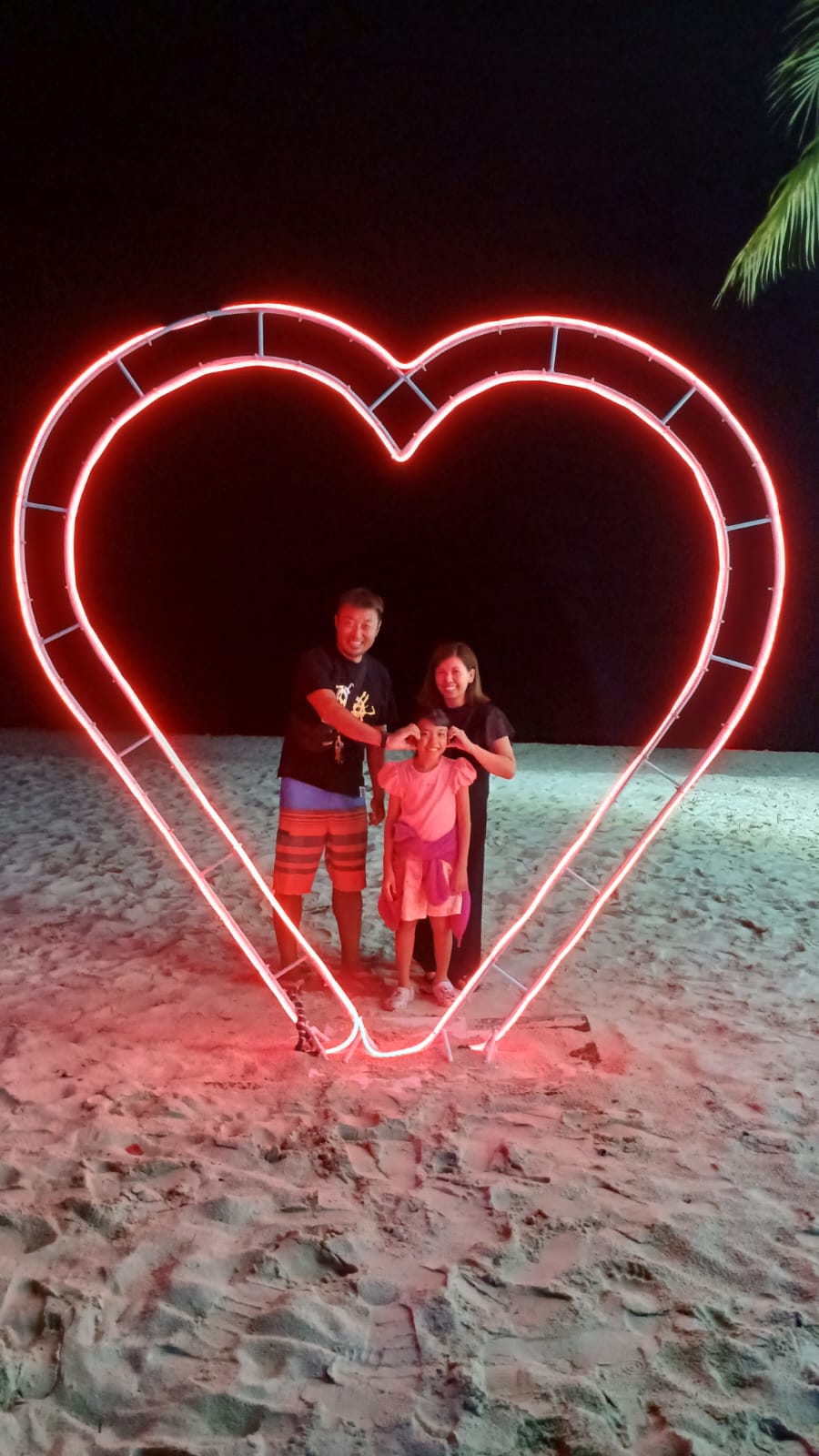 Photo shows Ai Nonogaki posing with her parents.