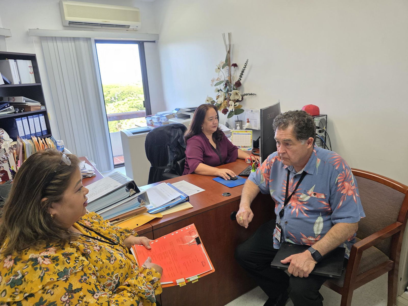 CUC Executive Director Kevin Watson, right, with Chief Financial Officer Betty Terlaje, left, and Betty Diaz, CUC management analyst.