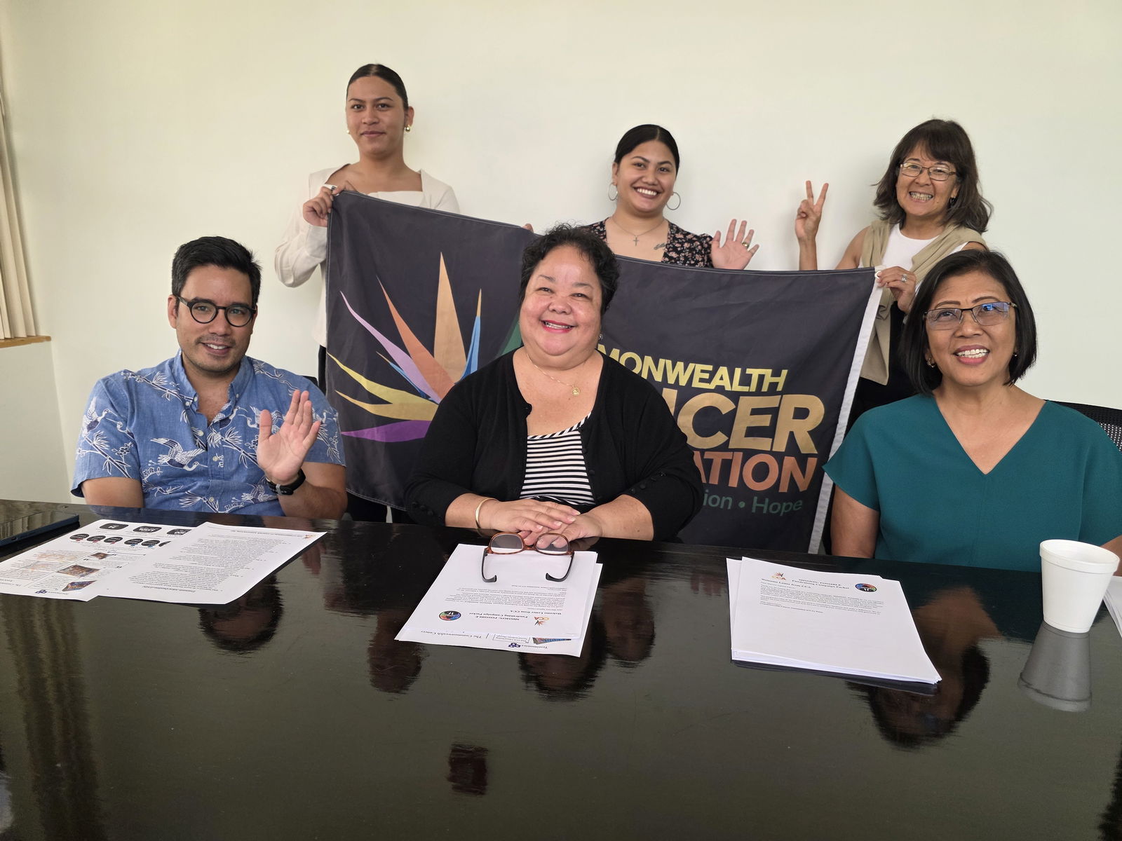 Commonwealth Cancer Association Board of Directors President Jocelyn Deleon Guerrero, center, board member Roman "Bo" Tenorio Palacios, left seated, client services and administrative coordinator Mercilia Teigita, center backrow, treasurer Rose Soledad, right, seated, interim executive director Lynn Tenorio, right backrow, and community outreach and social media coordinator Fran’Ko Deleon Guerrero pose for photo after a press conference on Thursday at the CCA office in Puerto Rico.Photo by Emmanuel T. Erediano