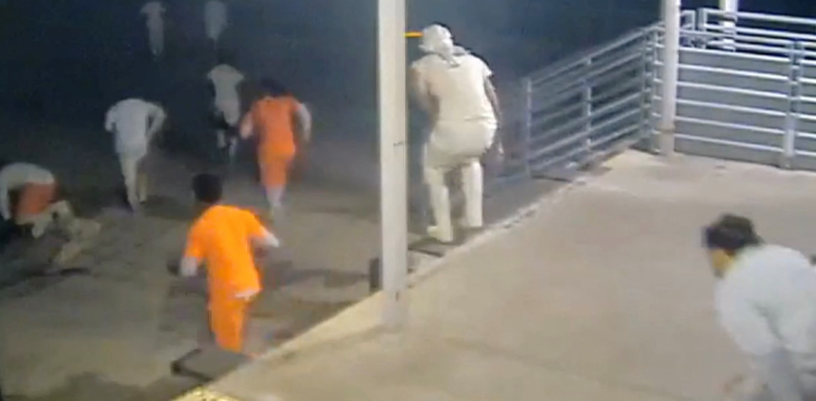 A screen grab taken from a handout CCTV video shows inmates running through the loading dock at the Orleans Parish Justice Center, in New Orleans, Louisiana, May 16, 2025.Orleans Parish Sheriff's Office/Handout via REUTERS