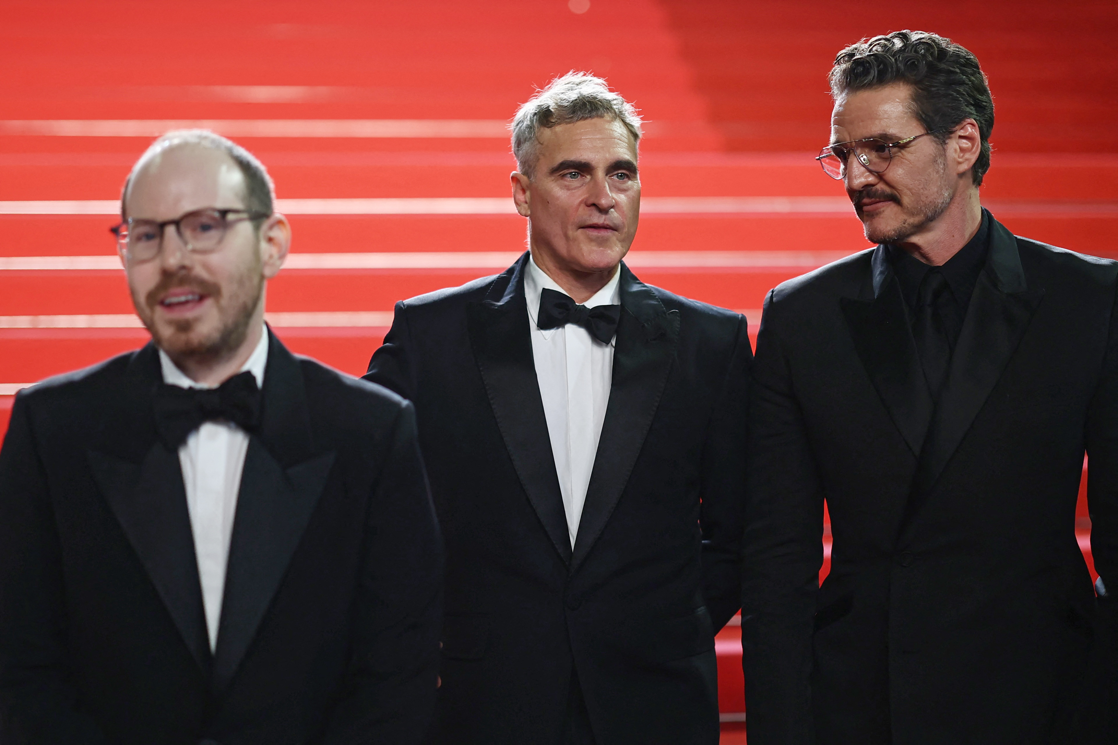 Director Ari Aster and cast members Pedro Pascal and Joaquin Phoenix pose on the red carpet as they leave following the screening of the film “Eddington” in competition at the 78th Cannes Film Festival in Cannes, France, May 16, 2025.REUTERS