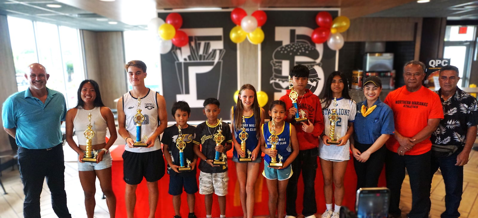 The MVPs of the PSS-McDonald's All School Track and Field (Athletics) Championships pose for a group photo during the awards ceremony at McDonald's Middle Road on Tuesday.Photo by James F. Sablan Jr.