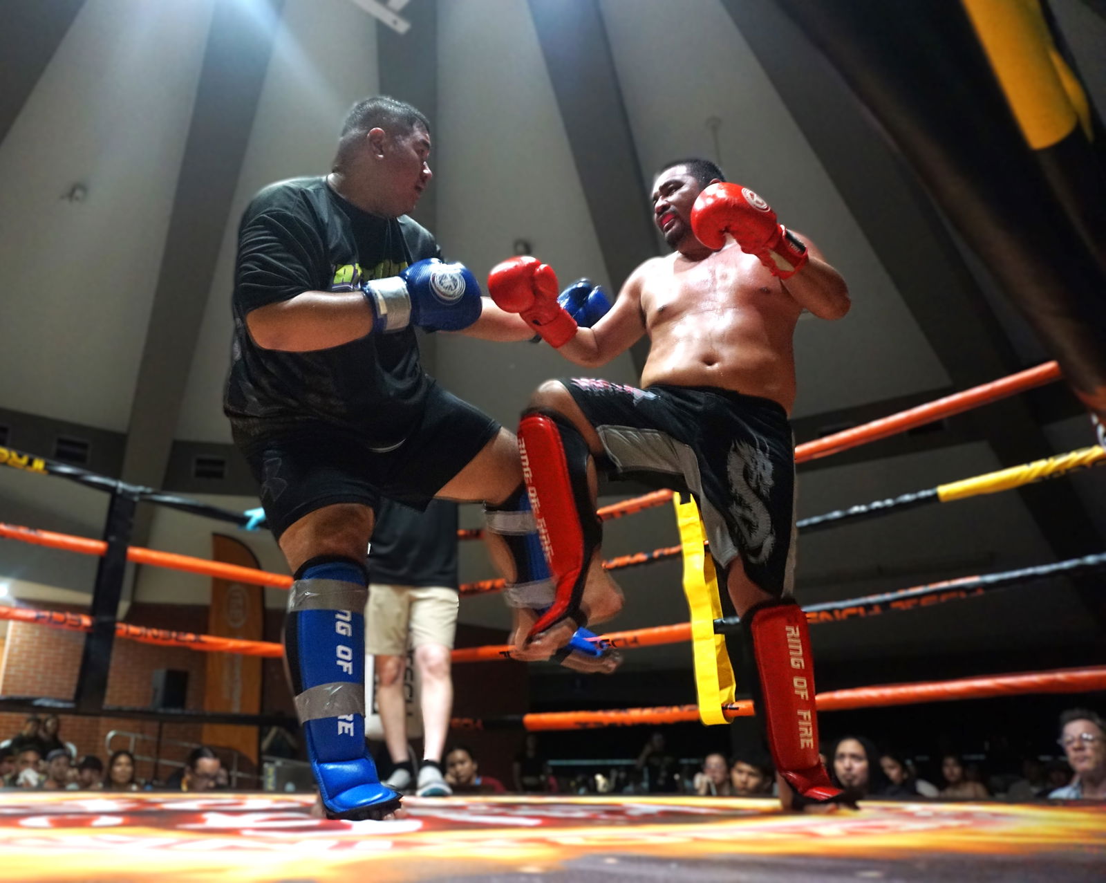 Richard Salas’ leg kick is checked by Junn San Nicolas during the heavyweight big brawl bout at Ring of Fire 3 at the Garapan Round House on Saturday.Photo by James F. Sablan Jr.