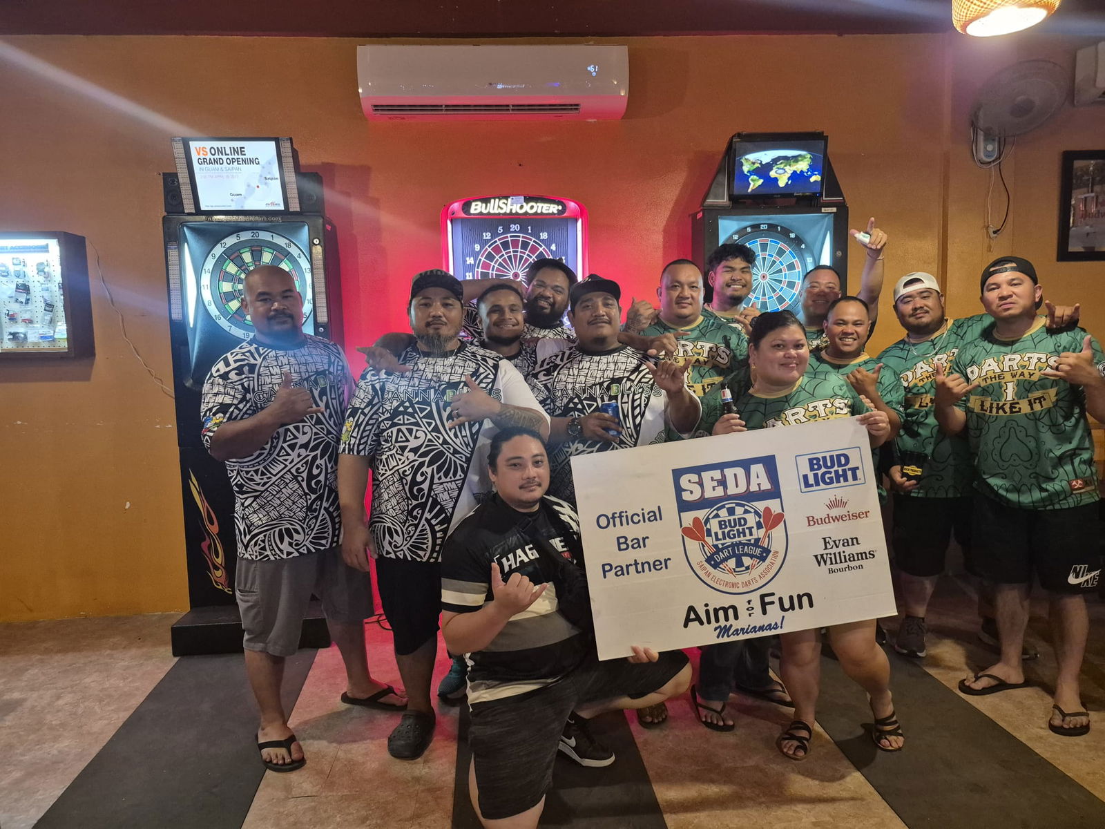 The Hut Darts d Way I Like it and Tom Yum Puff Daddy players pose for a group photo after their Thursday Flame Tree B Division game in the 2025 SEDA Bud Light Dart League at the Tom Yum Restaurant on Thursday last week.Contributed photo