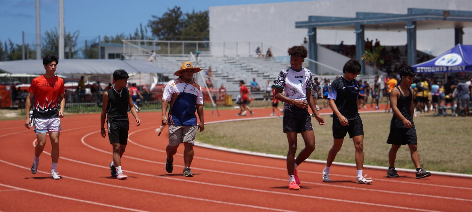 The competitors of the boys 18U 4x100M event make their way to their respective starting points on Saturday.Photo by James F. Sablan Jr.