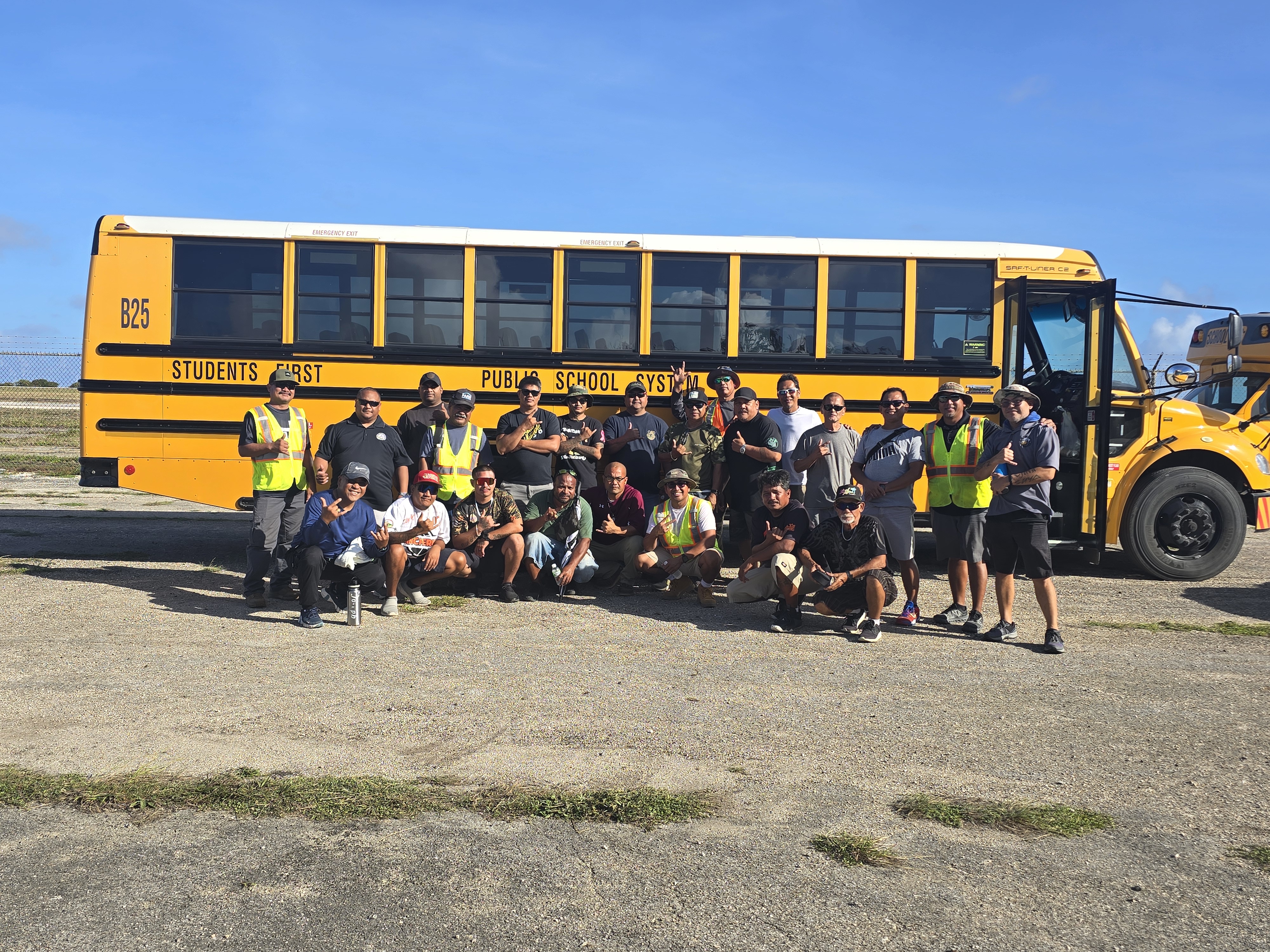 Public School System bus drivers who participated in the inaugural Driver Skills & Maneuverability Training Course pose for photo with PSS Office of Pupil Transport safety officer and training coordinator Joseph Muna, second right, and OPT staff. The training is part of PSS’ professional development program for its school bus drivers.
