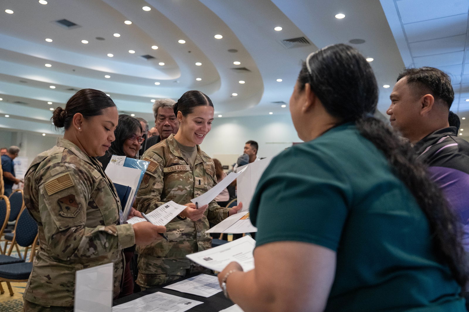 1st Lt Julieth Collazos and MSgt Sheleena Cruz meet with representatives of a CNMI-based company during the Saipan Industry Day Networking Session.