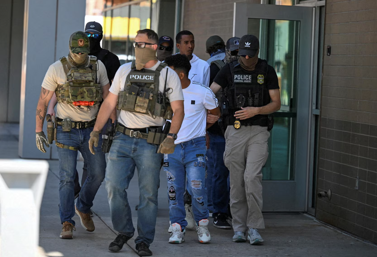 Law enforcement officers, including HSI and ICE agents, take people into custody at an immigration court in Phoenix, Arizona, May 21, 2025.REUTERS