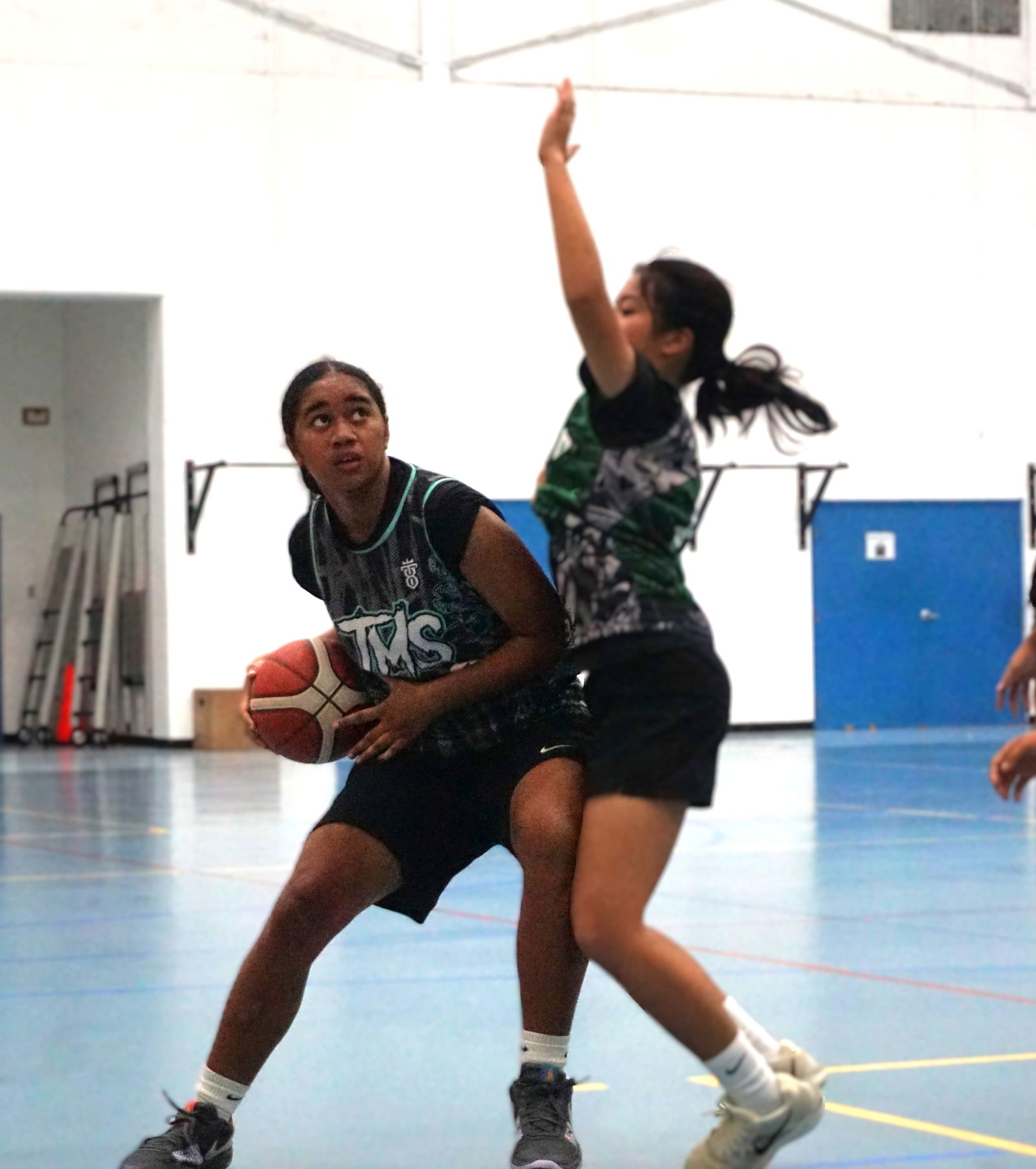 Tanapag Middle School's Aaleyah Fatialofa backs down against Hopwood Middle School's Maria Enriquez.Photo by James F. Sablan Jr.