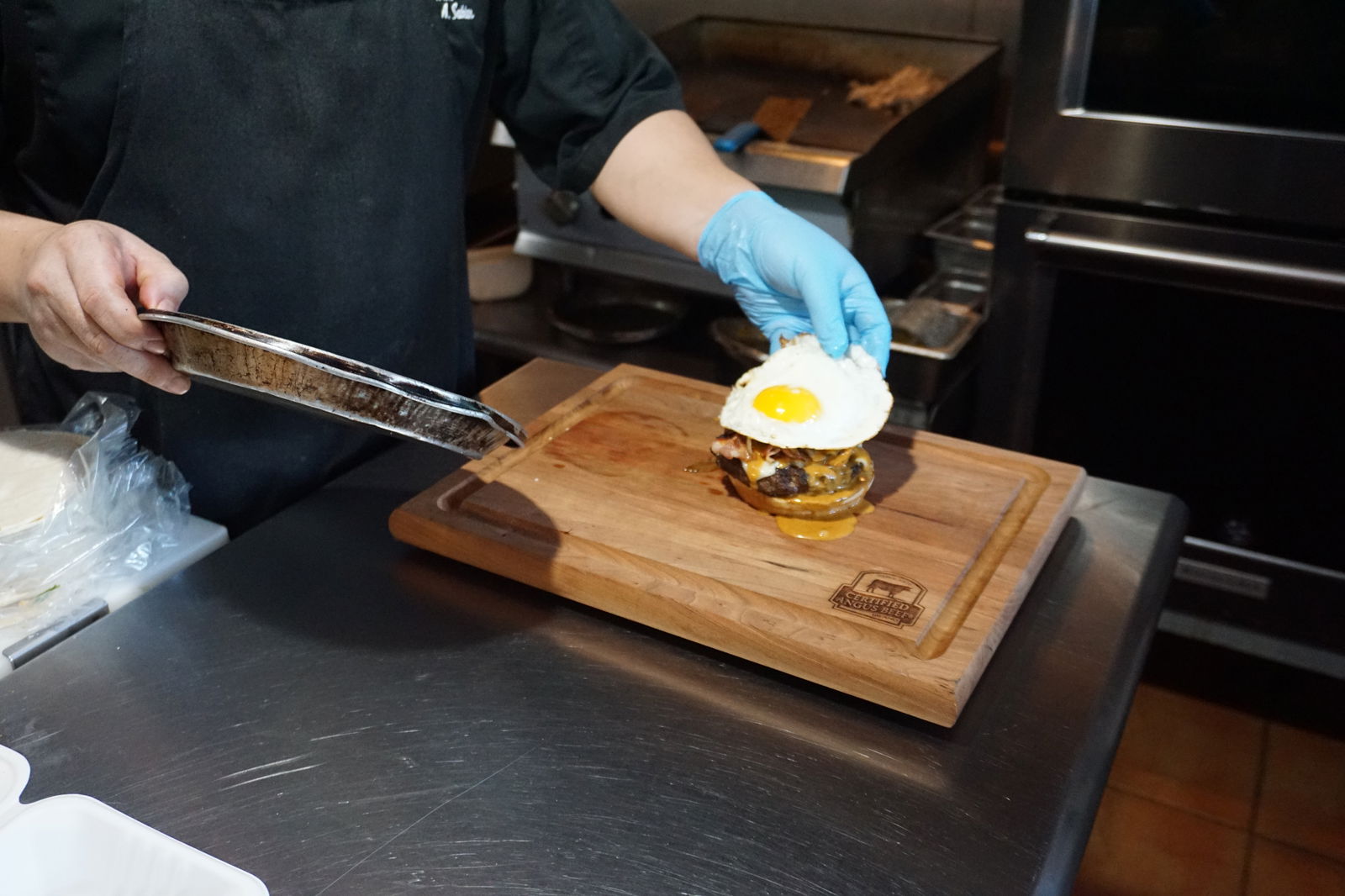 Chef Sonny Sablan puts the finishing touches on Kaksaka Burger.