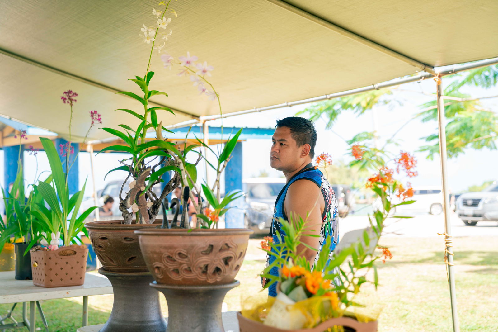 Saipan Orchid Show 2nd Place winner of the Ground Orchid Category Rodrigo Ada gazes at orchids on display.NMC photos
