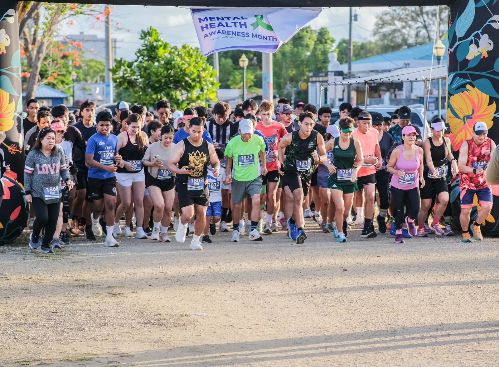 Runners take off from the starting point of the Mind, Body and Sole 5K at the Garapan Fishing Base on Friday.Contributed photo