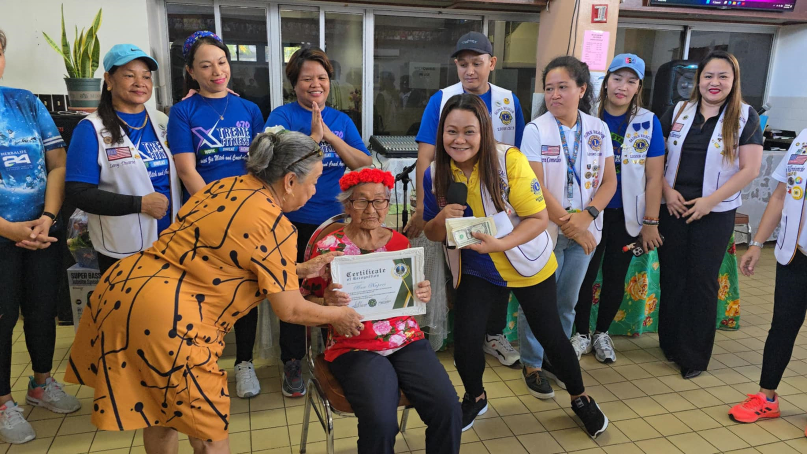 The Saipan Beacon Lions present a special prize package to the oldest client of the Office on Aging, Ana Naperi.