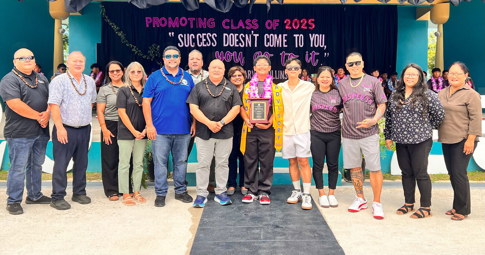 Class salutatorian Branden Asher Pagalpalan Reyel received the Commissioner of Education Academic Excellence Award, from Commissioner of Education Dr. Lawrence F. Camacho and his leadership team. Also in photo are BOE members and Reyel’s family members.