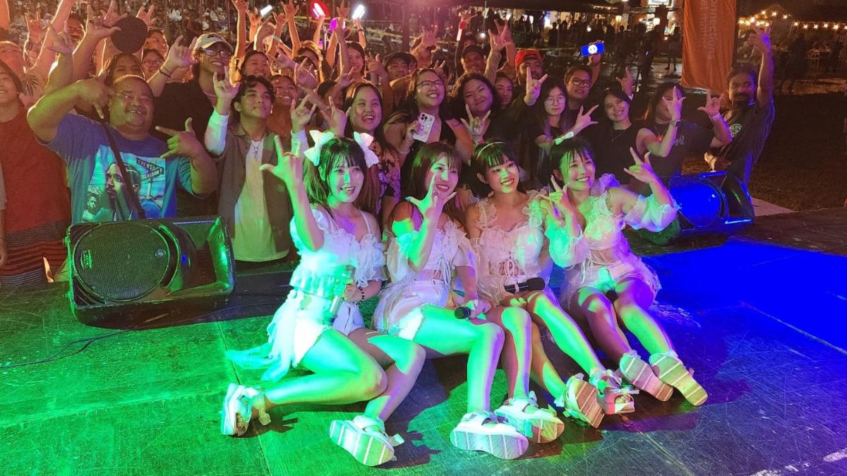 Newly named Marianas Goodwill Ambassador SkySyllabus take a photo with festivalgoers following their live performance at the 26th Annual Taste of The Marianas International Food Festival on May 24, 2025, at American Memorial Park, Saipan. The J-pop group is also filmed their second music video in Saipan during their recent visit.