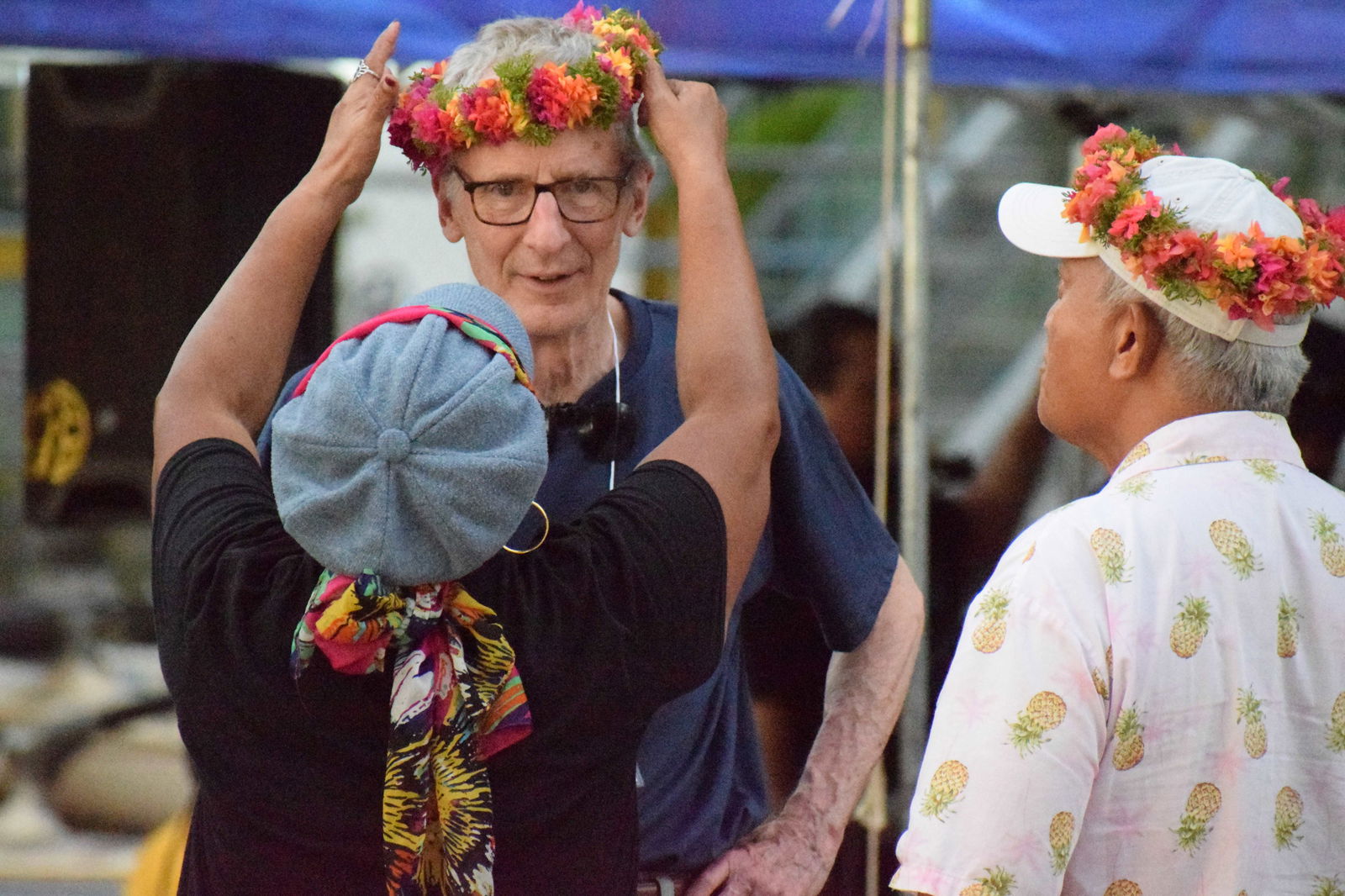 Florencia Selepeo Kirby welcomes Tom Zink with a mwar as Louie Wabol looks on.