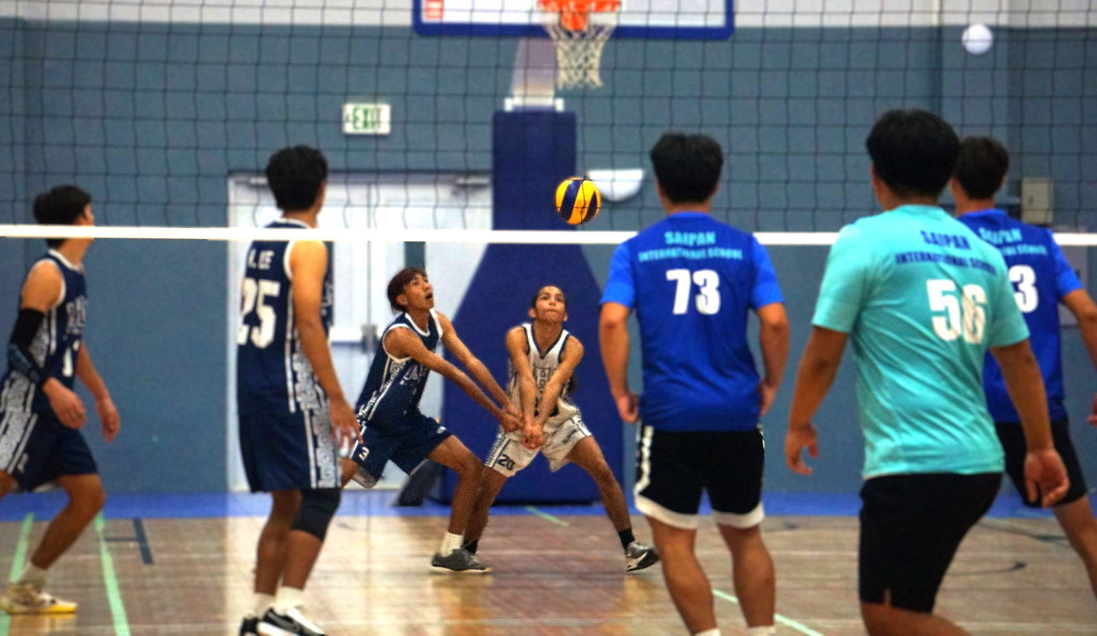 Two MHS players reach out for the bump return.